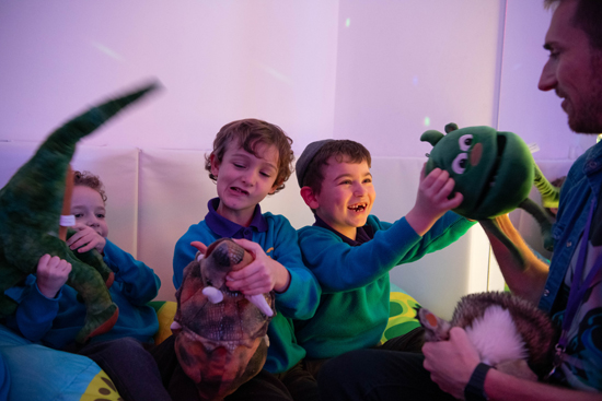 Dramatherapy session with Mr Chris Dramatherapist in the sensory room using puppets as a tool to explore social and emotional understanding